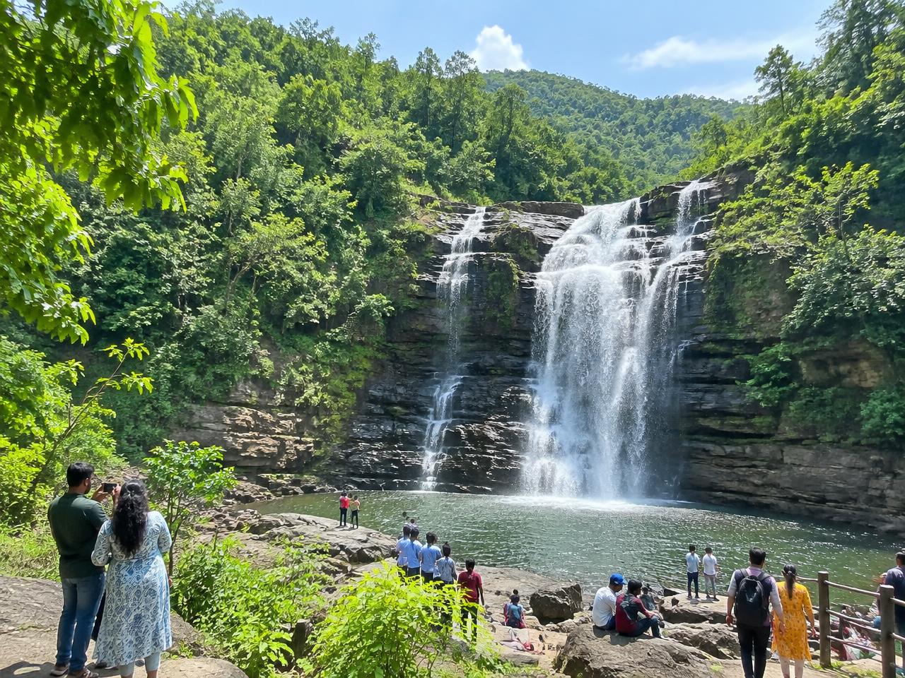 A waterfall in a green forest valley